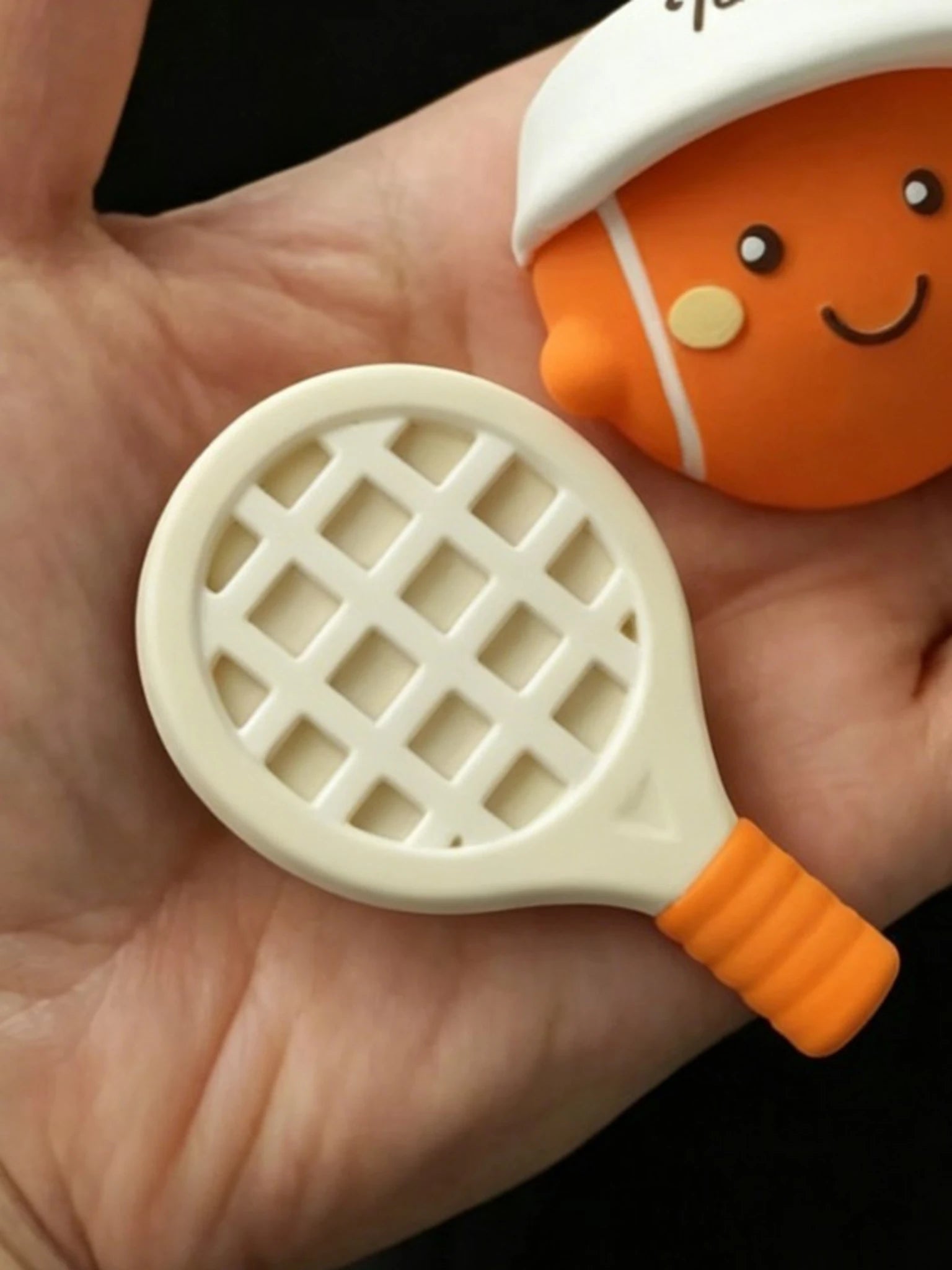 Close detail of the racket lattice and sculpted tennis pieces