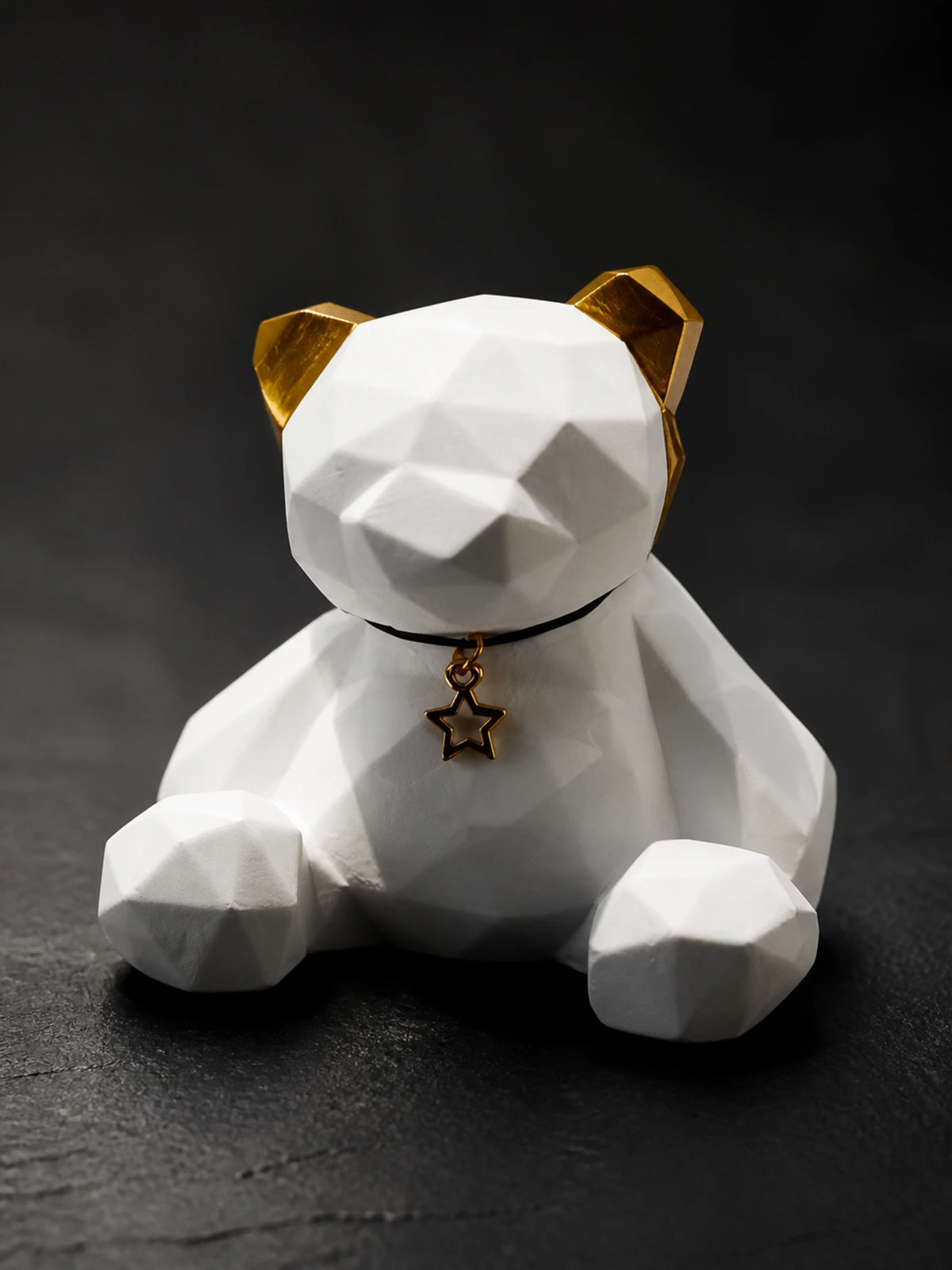 Close detail of the Golden Ear bear faceted white surface and seated form