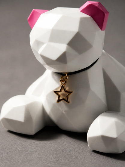 Close detail of the Rose Ear bear black collar and hollow gold star pendant
