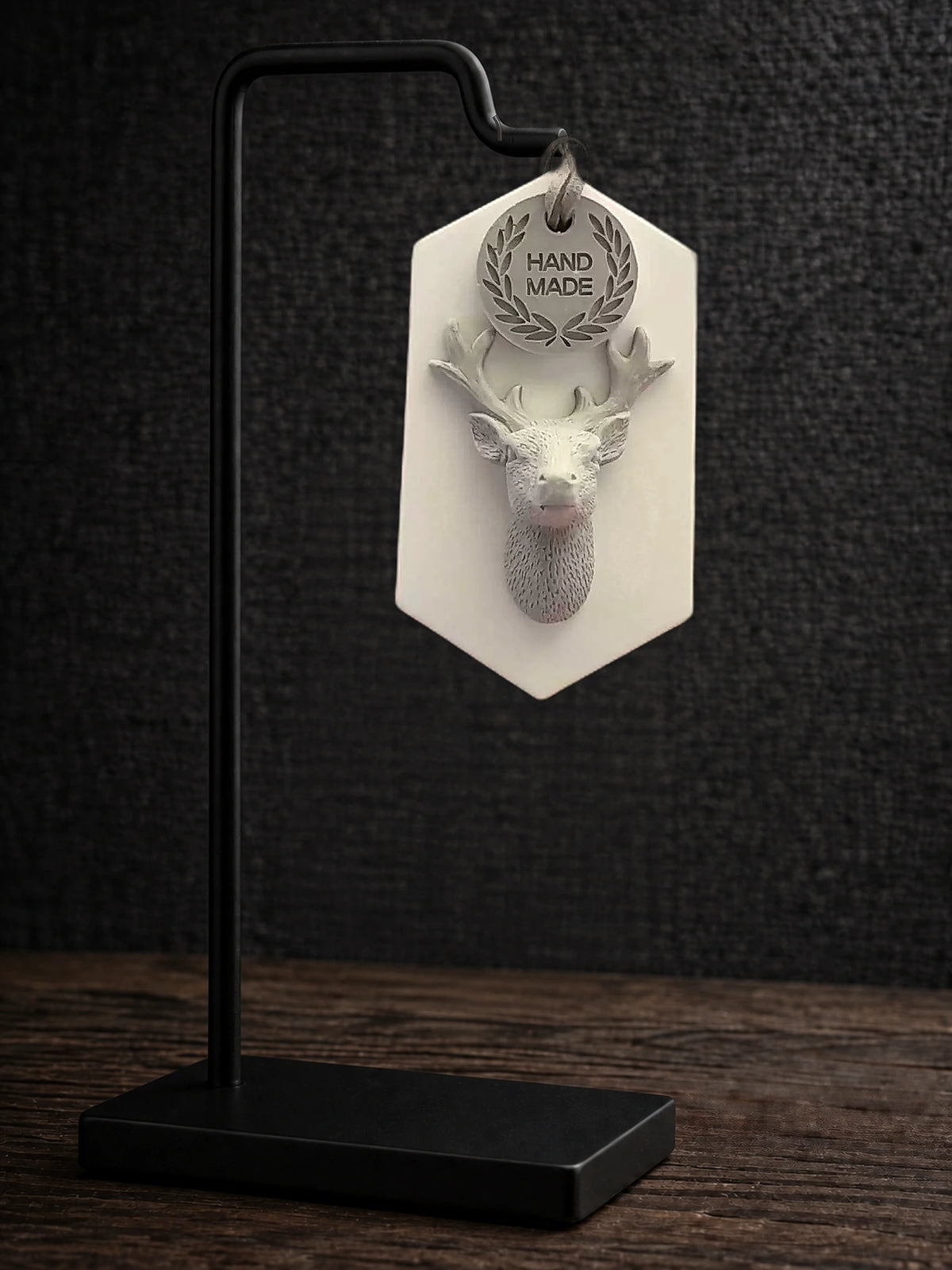 Complete white-plaque gray stag ornament on a black display stand