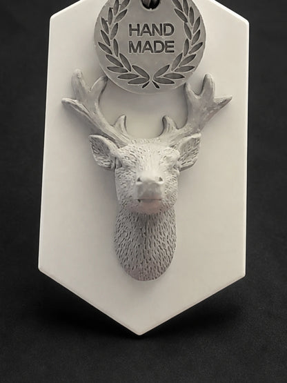 Close detail of the raised stag head, antlers and textured neck relief
