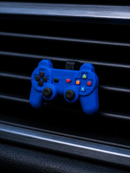 Retro game controller vent ornament in a blue-hour car interior