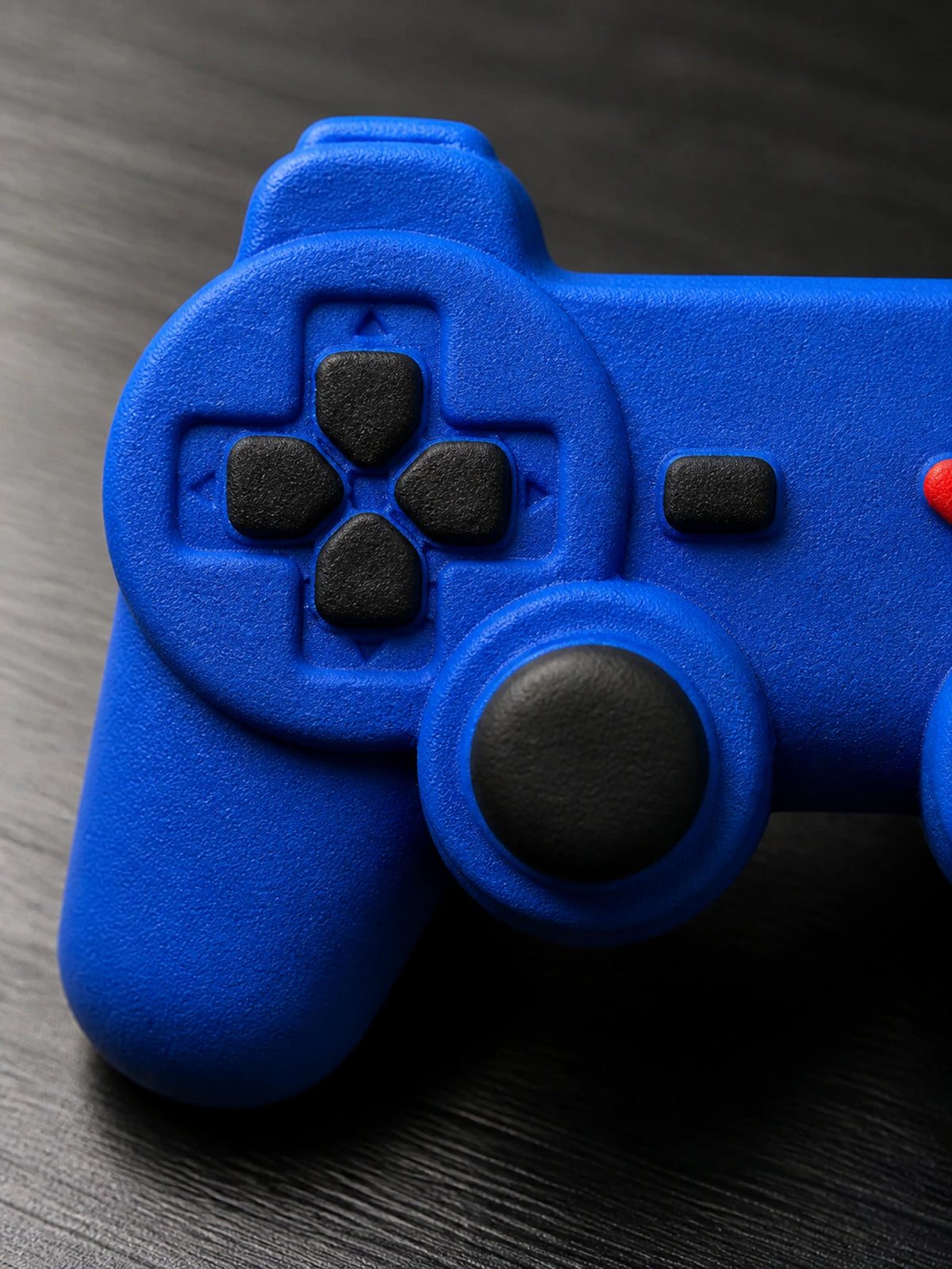 Macro detail of the black directional pad, analog controls and center button