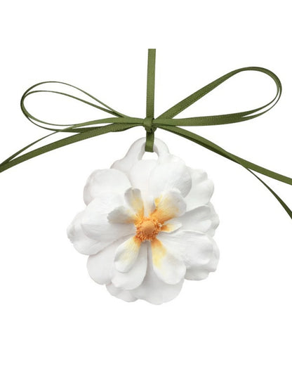 Close detail of the layered peony petals and narrow hanging ribbon