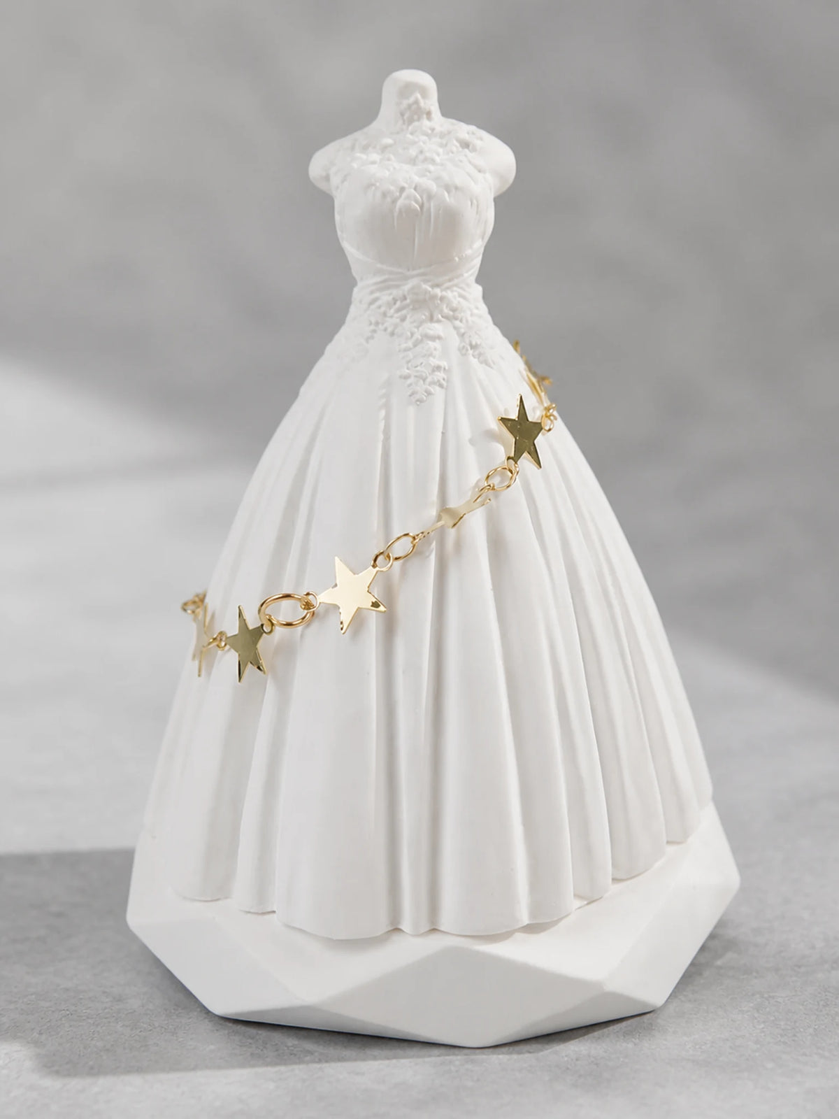 Close detail of the bridal bodice relief and sculpted white surface