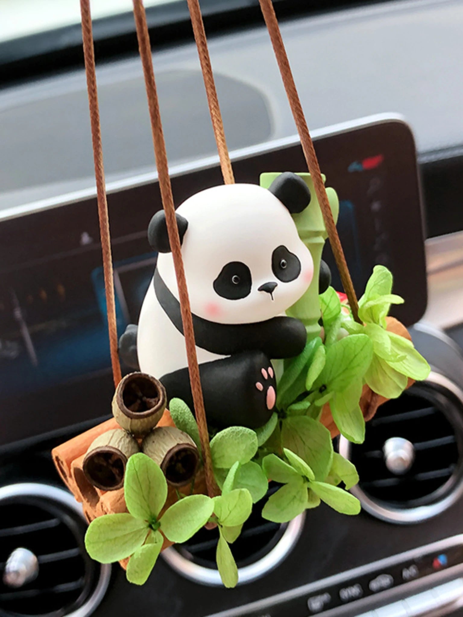 Bamboo Panda car charm hanging naturally below a rearview mirror