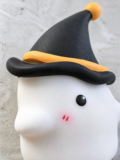 Side macro view of the pointed hat, orange tip and white ghost form