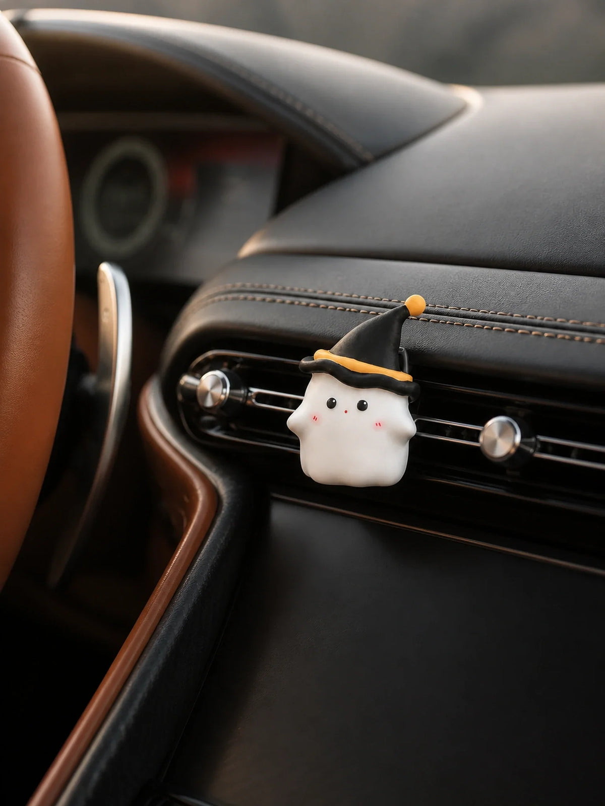 Midnight Ghost ornament clipped cleanly to one Aston Martin DB12 vent slat