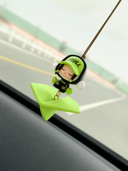Green Wanderer Airplane Hanging Car Charm suspended beside a vehicle windshield