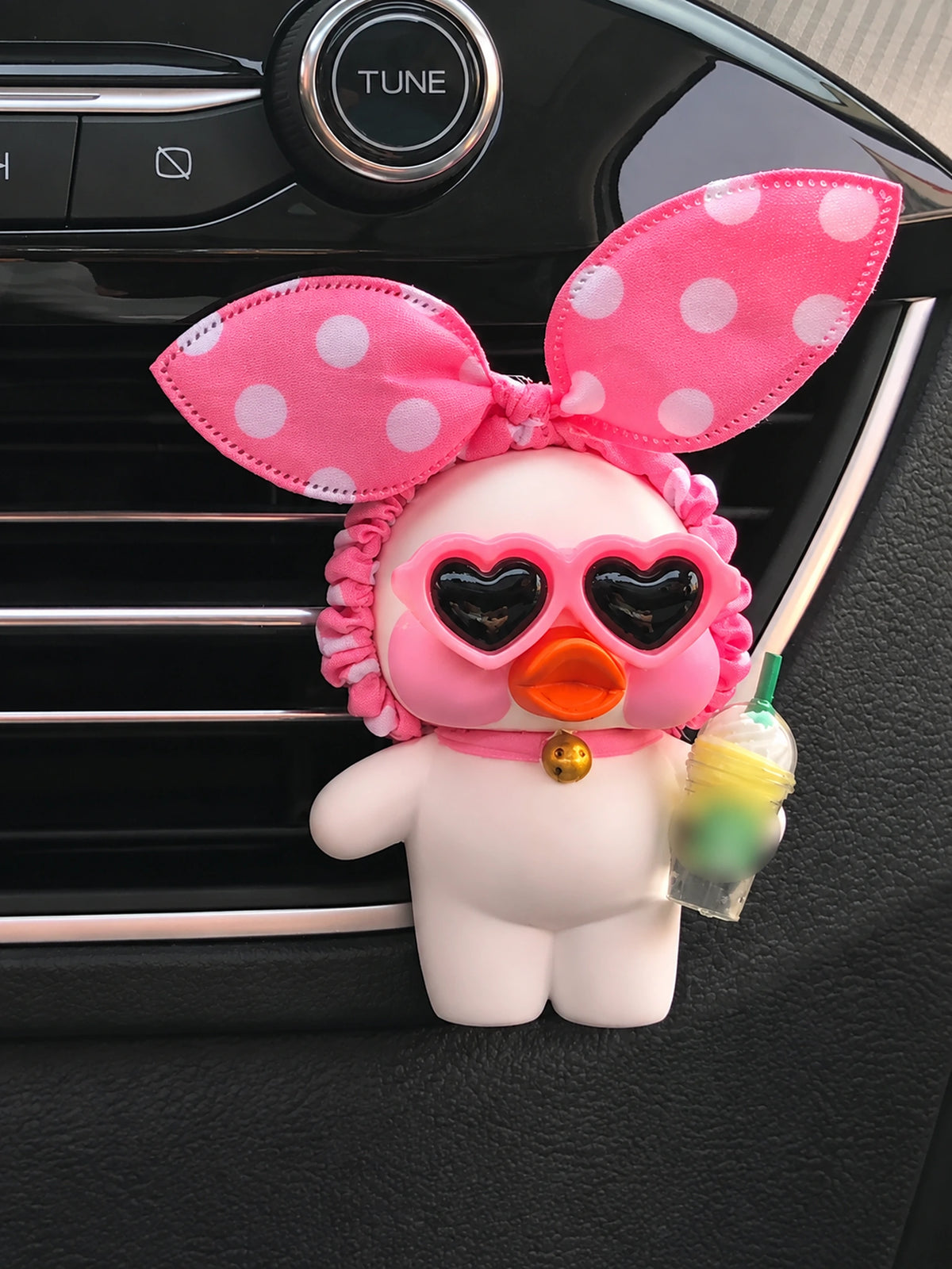 Heart Glasses Duck with pink polka-dot bow, heart sunglasses and decorative cup on a car vent