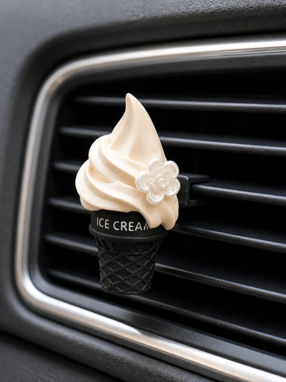 Vanilla Cone car vent charm secured to a horizontal air vent