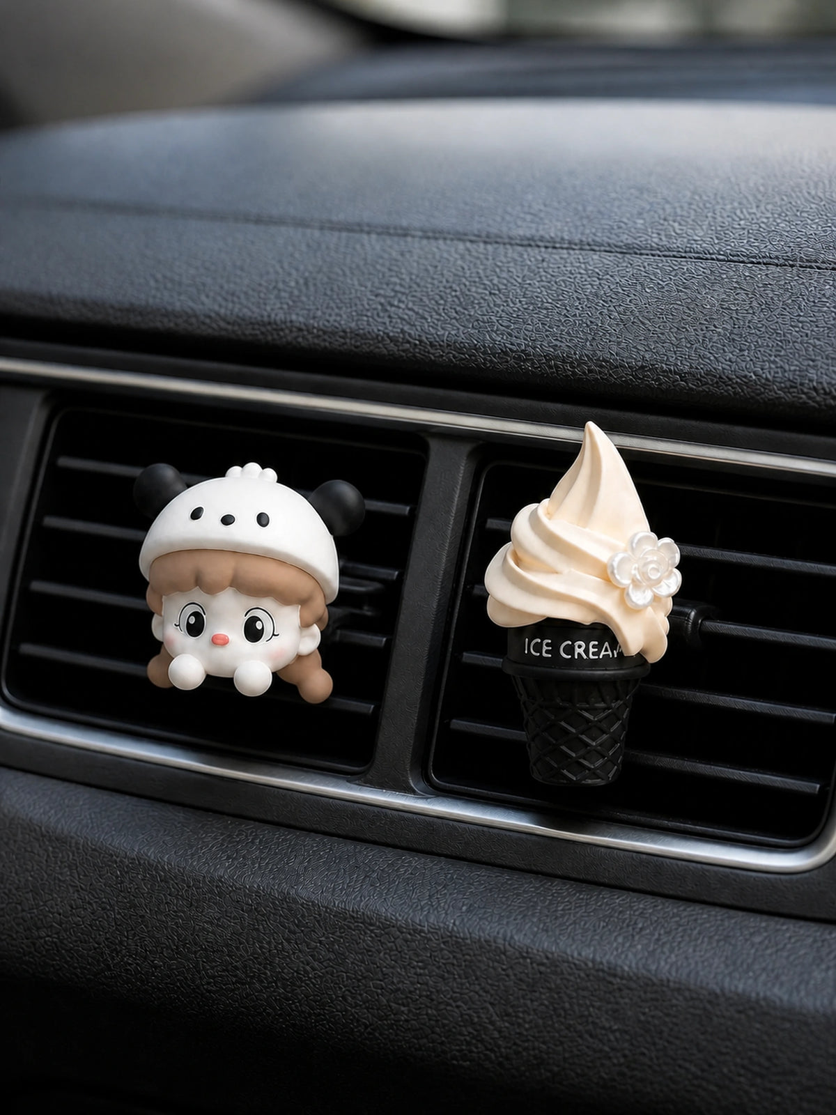 Cream Cap Girl and Vanilla Cone car vent charms secured to adjacent horizontal vents