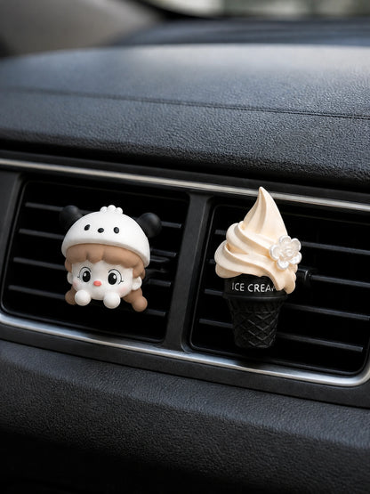 Cream Cap Girl and Vanilla Cone car vent charms secured to adjacent horizontal vents