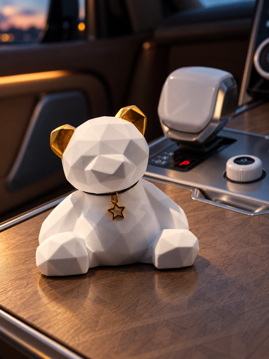 Golden Ear Bear on a level closed wood console lid in a parked Range Rover SV at dusk