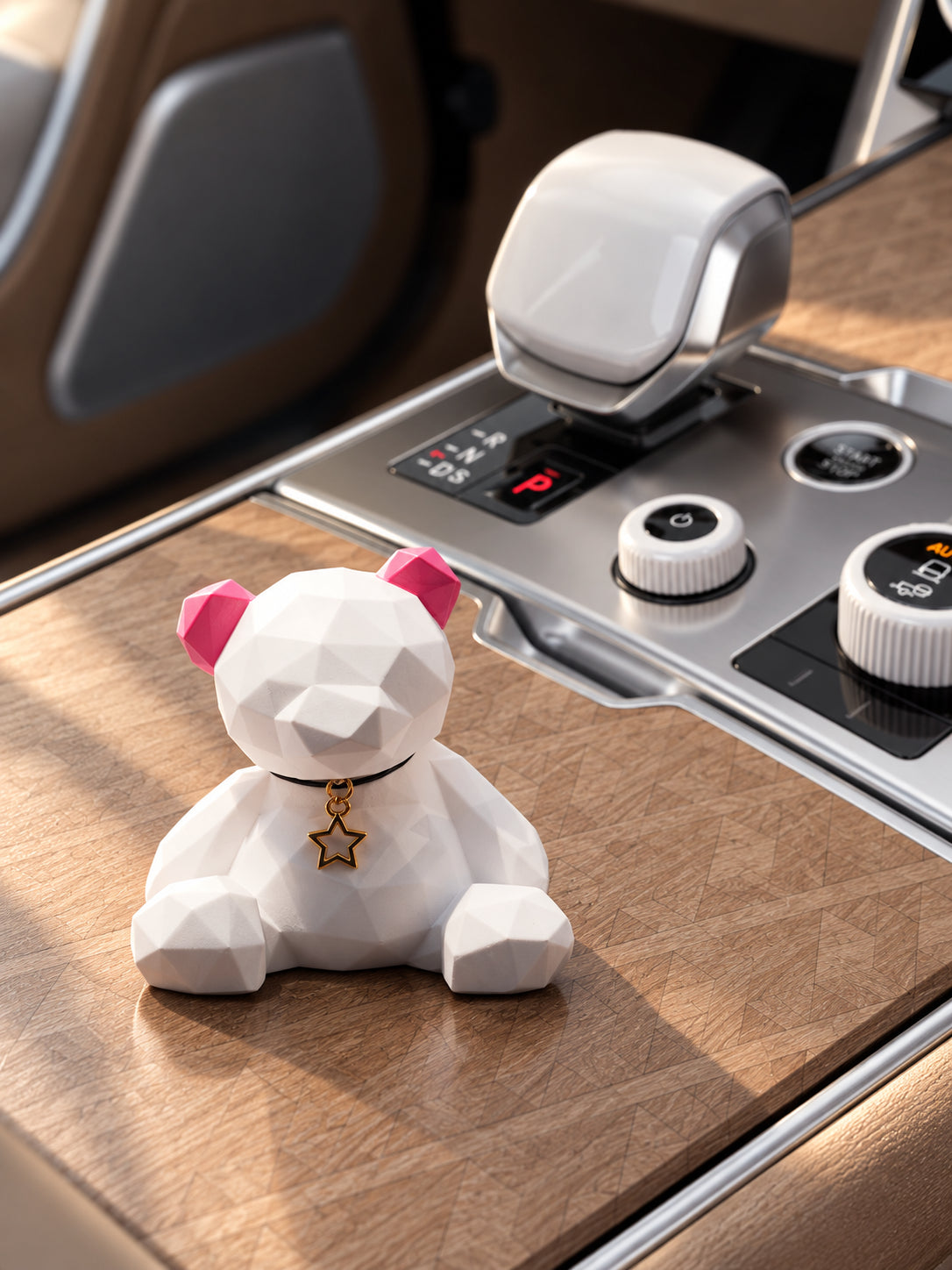 Rose Ear Bear on the closed wood storage lid in a parked Range Rover SV