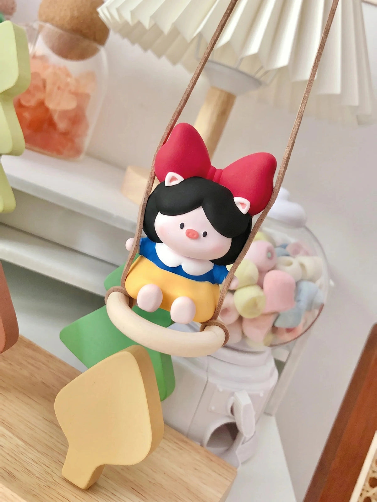 Pig Princess diffuser hanging indoors on green chair