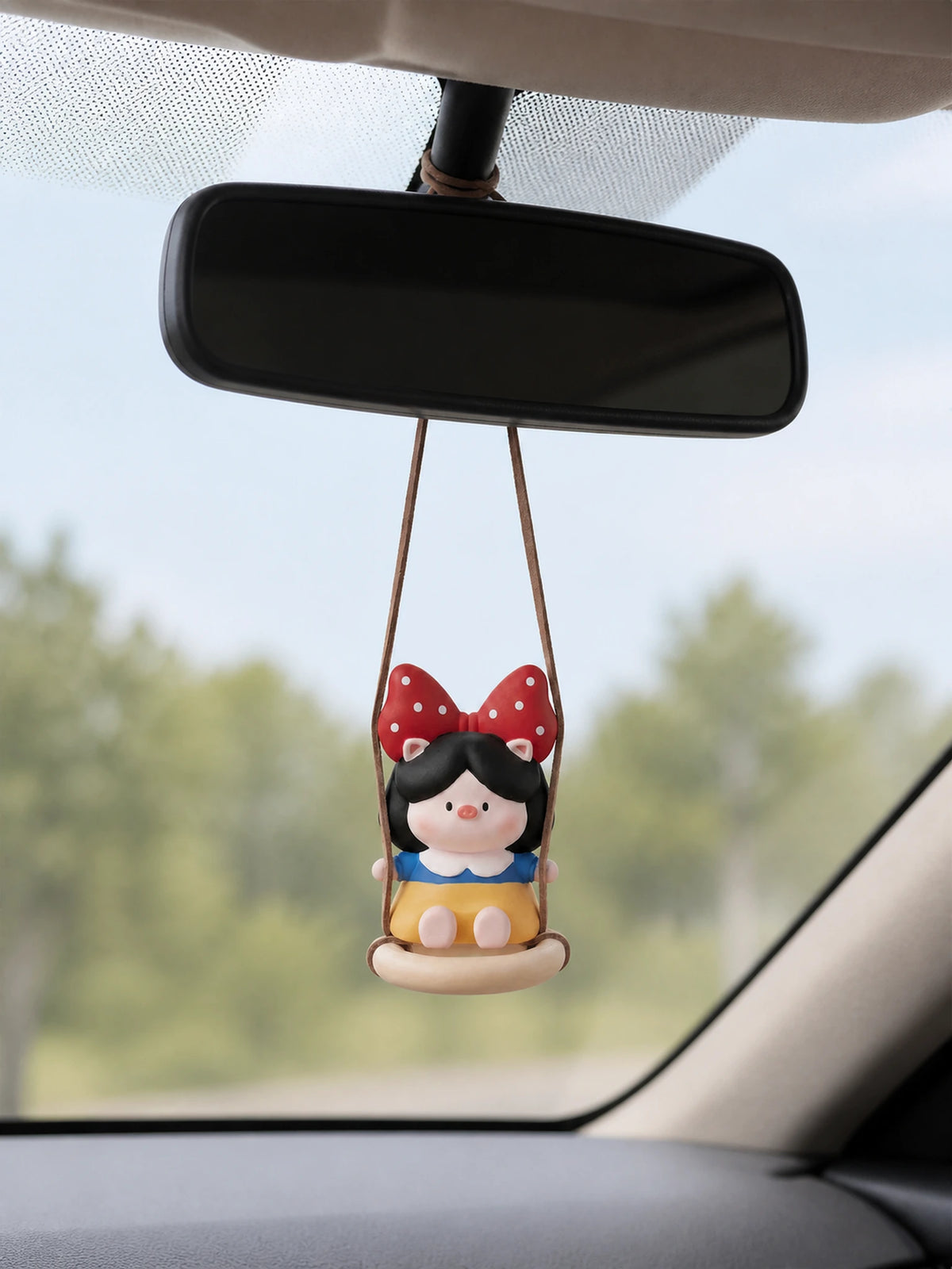 Pig Princess diffuser swinging on car rearview mirror