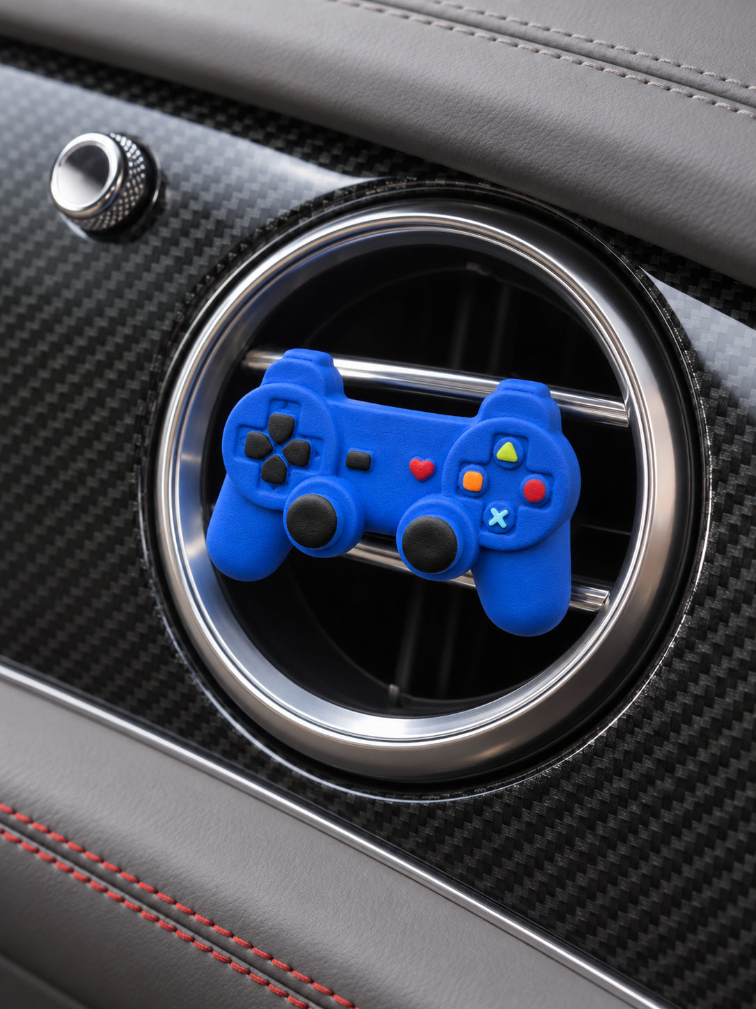 Oblique close view of the cobalt-blue controller ornament in front of a Bentley Bentayga circular passenger vent