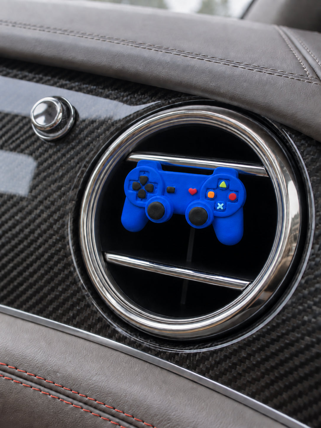 Cobalt-blue controller ornament in front of a Bentley Bentayga circular passenger vent