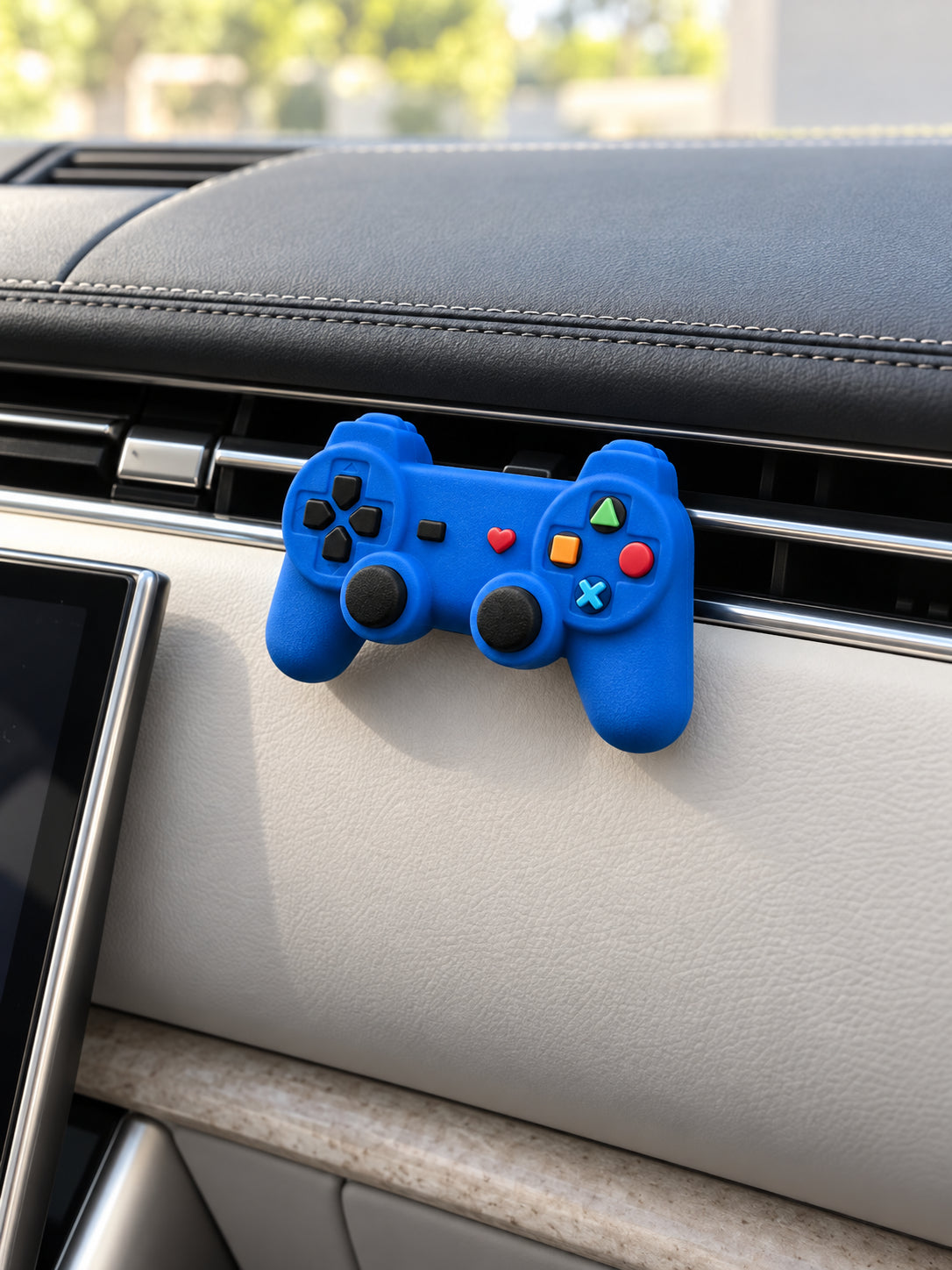 Cobalt blue controller ornament clipped to a slim horizontal vent in a parked Range Rover SV