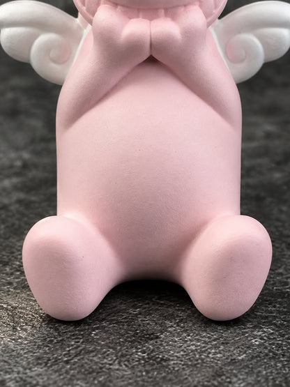Macro detail of the Wish Pig's matte pink belly, clasped hands and two oval feet