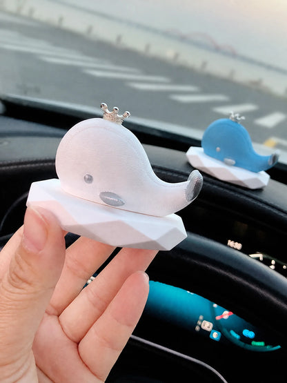 Whale diffuser set on black car dashboard